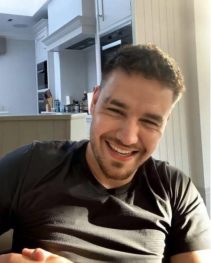 Liam Payne Wall Art canvas featuring vibrant and detailed portrait of smiling man in casual black shirt in modern home setting