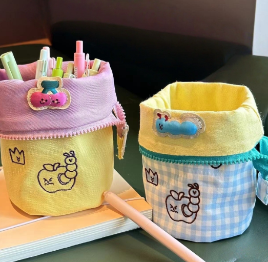 Simple vertical flip large capacity pencil cases with cute embroidered designs and pastel colors filled with pens and markers