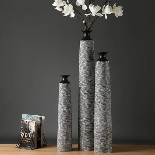 Northern Resin Cafe luxury floor vase set with textured gray bodies and black tops displayed on wooden surface with flowers and magazines